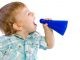 baby boy shouting through a toy like megaphone, isolated